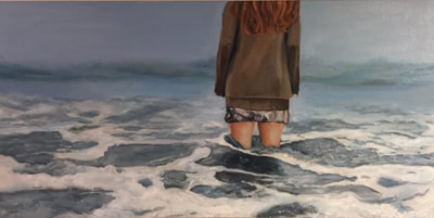 girl wearing a skirt in the ocean looking into the horizon looking lost.