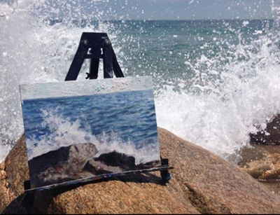 plein air painting of ocean splashing against the rocks